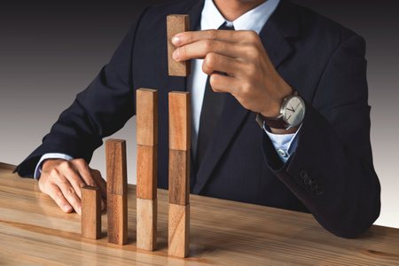 Businessman hand arranging stacking wooden blocks development as step stair, Business growth success...
