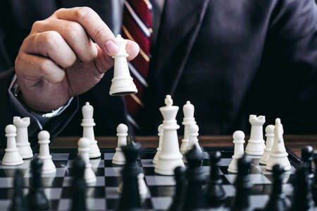 Close up of hands confident businessman colleagues playing chess game to development analysis new...