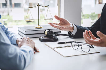 Consultation and conference of Male lawyers and professional businesswoman working and discussion having at law firm in office. Concepts of law, Judge gavel with scales of justiceの写真素材