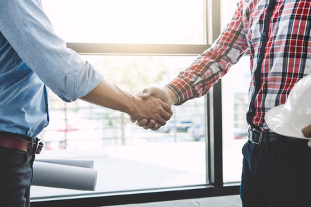 Meeting and greeting, Two engineer or architect meeting for project, handshake after consultation and conference new project plan, contract for both companies, success, partnershipの写真素材