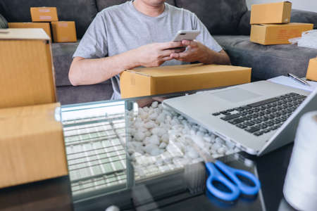 Small business parcel for shipment to client at home, Young entrepreneur SME freelance man working...
