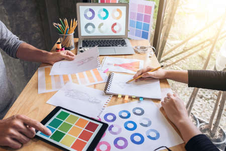 Two young dressmaker or designer colleagues working and discussing fashion project designers and drawing sketches for clothes, profession and job occupation, Fashion Designer Stylish Conceptの写真素材