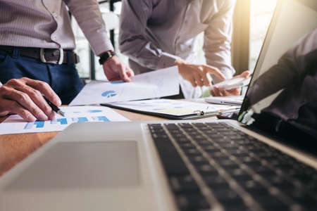 Business team meeting working with new startup project, discussion and analysis data the charts and graphs. Digital tablet, calculator, laptop computer using, Business finance and accounting conceptの写真素材