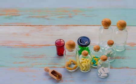 medicine in a glass bottle is placed on a wooden floorwith copy space. Medical and health care conceptsの写真素材