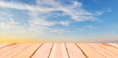 Natural wood planks and blue sky background
