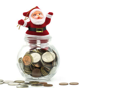Santa claus and money coins in glass isoalted on white background, concept as gift and reward in Chirstmas day.の写真素材