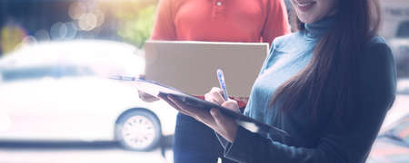 Delivery man by sending box of parcel to customers service at home as having Coronavirus disease or covid 19 spreadingの写真素材