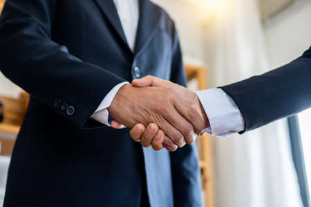 successful negotiate and handshake concept, two businessman shake hand with parthner to celebration partnership and teamwork, business dealの写真素材