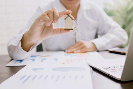 business man holding house model, real estate conceptの写真素材