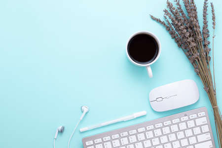 Minimal Office desk table with Keyboard computer, coffee cup, mouse, white pen, Earphones, lavender...