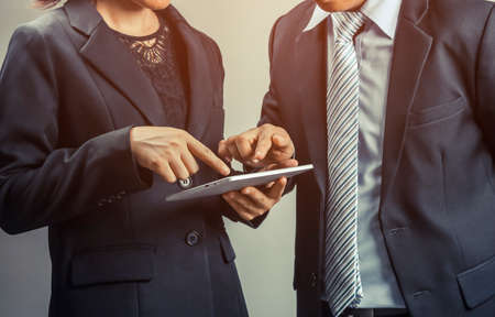 business people looking, consult and pointing at taplet about work maketting