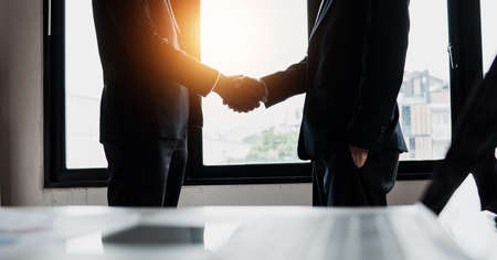 Successful negotiation and shake hand after success in sign business contractの写真素材