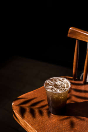 glass of iced coffee with milk on the tableの写真素材