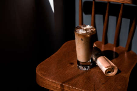 glass of coffee with milk on the tableの写真素材