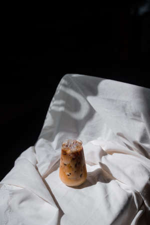 glass of iced coffee with milk on the tableの写真素材