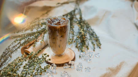 glass of coffee with milk on a white canvas