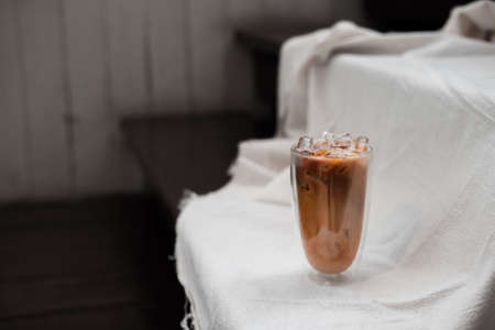 glass of iced coffee with milk on the tableの写真素材