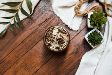 glass of coffee with milk on the tableの写真素材
