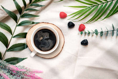 closeup black coffee cup put on linen fabric. top view
