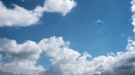 Blue sky with bright clouds background. Nature backdrop