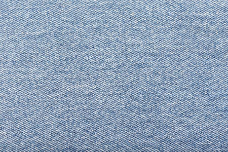 Light blue denim fabric background. Close up