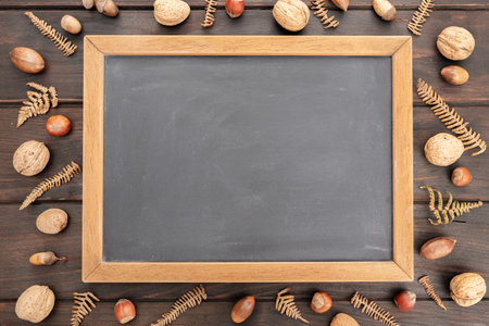 Blank Blackboard on rustic wooden table with autumn decoration. Mock up template. Fall Backdrop. Top viewの写真素材
