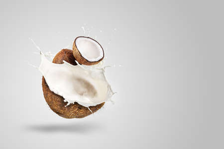 Coconut Milk Splashing isolated on Green backgroundの写真素材