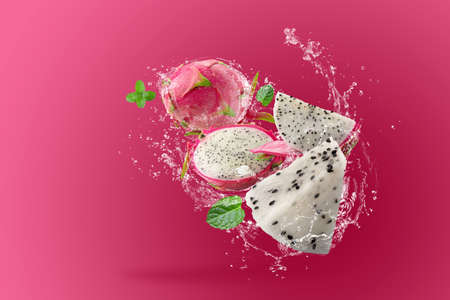 Water Splashing on Dragon Fruit or Pitaya over pink backgroundの写真素材