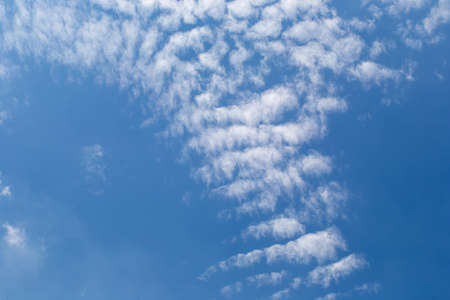 White fluffy clouds in the blue sky background