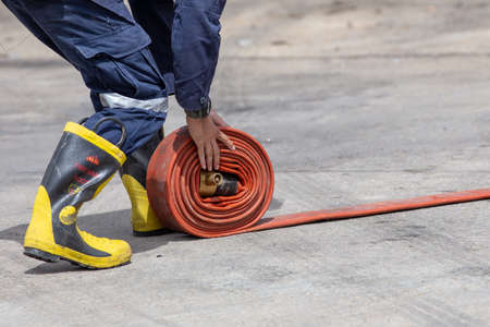 Firemen in firefighter uniform are keep their equipment after use
