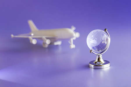 Glass globe and airplane model, travel and Globalization conceptの写真素材
