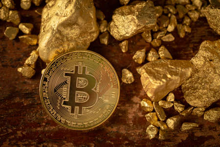 Gold bitcoin physical Bitcoin-Cryptocurrency and Gold nugget grains. Business conceptの写真素材