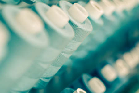 Blue Thread Spools / Long rows of blue thread spools filling the frame blur background and forgroundの写真素材
