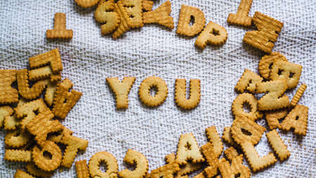 find you concept Cookies in the form of the alphabet prospect .Happy from homemade cookies on dark white background. Happy cookies concept.の写真素材