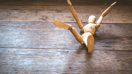 Wooden mannequin falling down. Fall concept.business.life.failure idea backgrouの写真素材