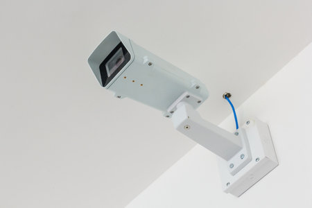 CCTV camera. Security camera on the white wall. Private property protection.