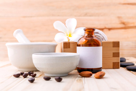 Natural Spa Ingredients sea salt ,coffee beans ,honey , almonds ,spa stones and white mortar on wooden background for scrub and skin care.の写真素材