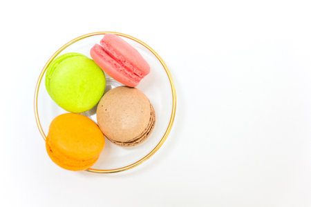 Sweet and colourful french macaroons or macaron in a glass bowl on white background, Top view with copy space for your text.の写真素材