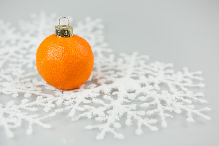 Tangerine as a xmas ball on Christmas and New Year isolated on a white background. Fir tree toy fruits concept design on holiday.の写真素材