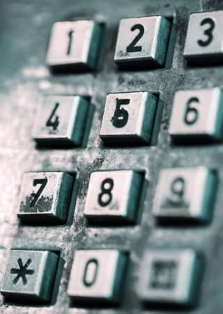 The buttons of an old-style street public telephone. Shallow depth of field.の写真素材