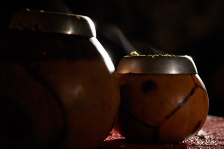 Two yerba mate calabashes with smoke. Low key shot.