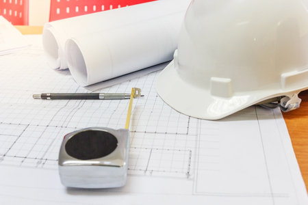 Workplace of architect - Architectural project, blueprints, blueprint rolls, pen and measuring tape...
