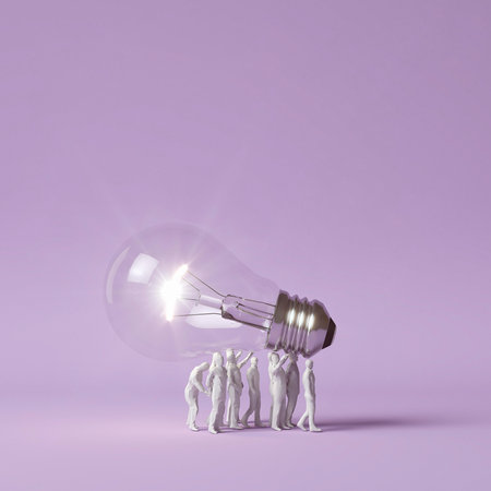Human figurines carrying lit lightbulb as idea conceptの写真素材
