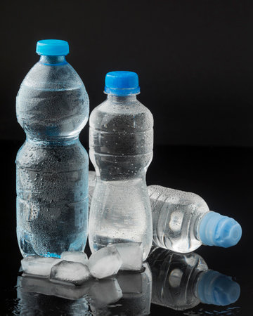 Ice cubes bottles water front viewの写真素材
