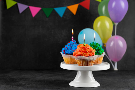 Birthday party cupcakes with candlesの写真素材