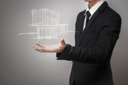 Businessman showing a model of the houseの写真素材