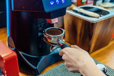Close-up of making coffee. Close-up image of male barista preparing fresh coffeeの写真素材