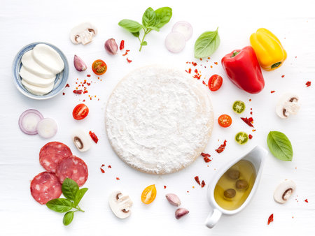 The ingredients for homemade pizza on white wooden background.の写真素材