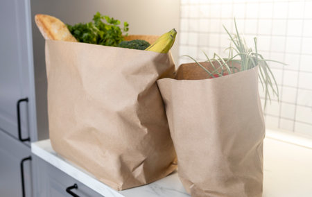 Two paper grocery bags kitchen counter with fresh produceの写真素材