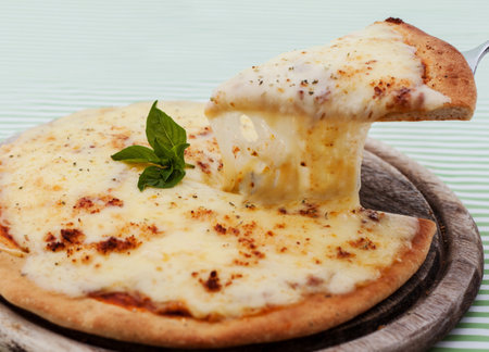 Delicious homemade pizza with ham and vegetables.の写真素材